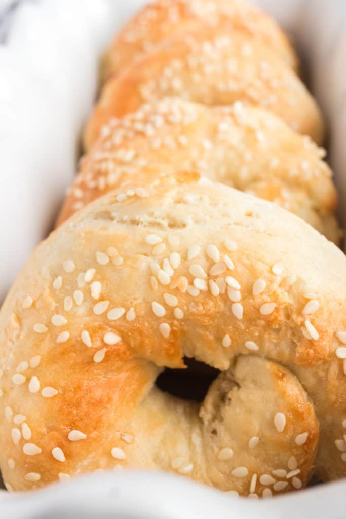 close up of air fryer bagels in a line in pan