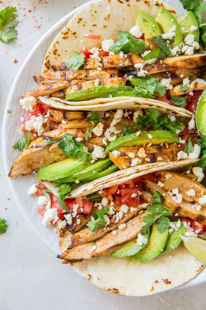 An over the top shot of Grilled Chili Lime Chicken Tacos on a white platter.