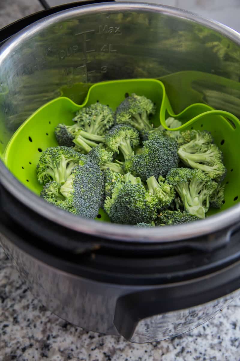 Chopped broccoli on a trivet inside an Instant Pot