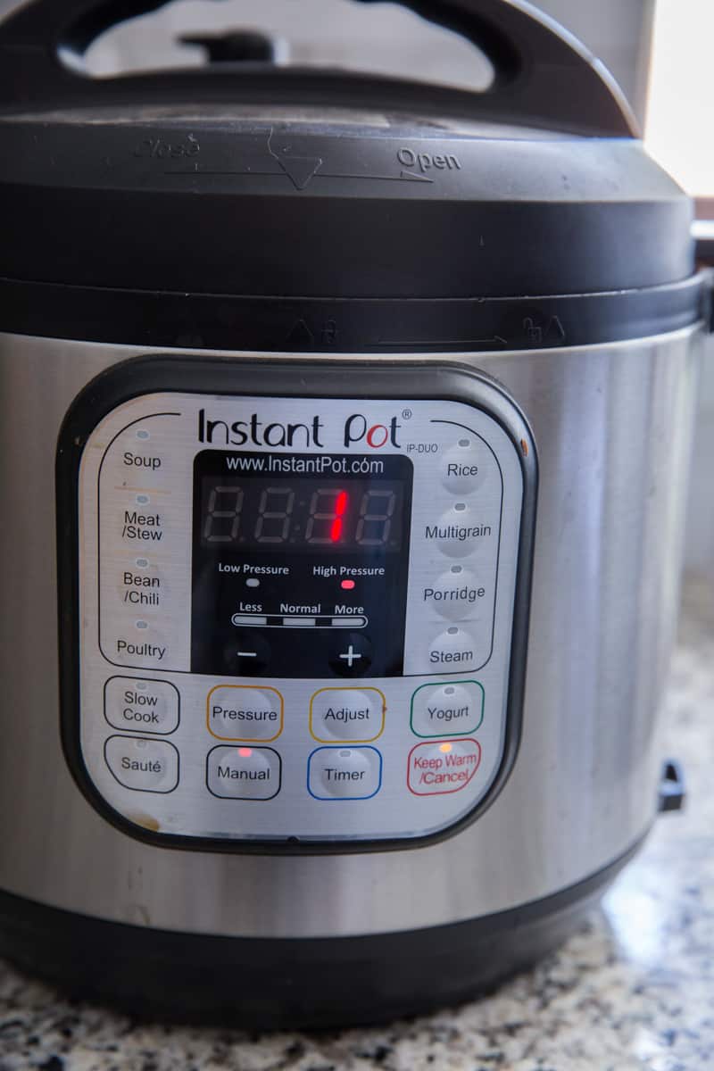 An Instant Pot with a lid on and timer set to 1 minute