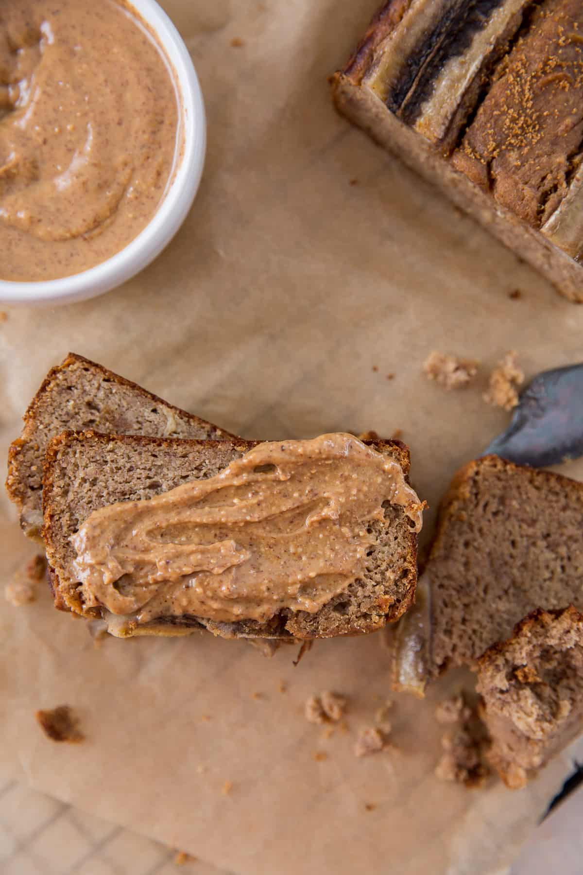 overhead view of sliced paleo banana bread topped with almond butter