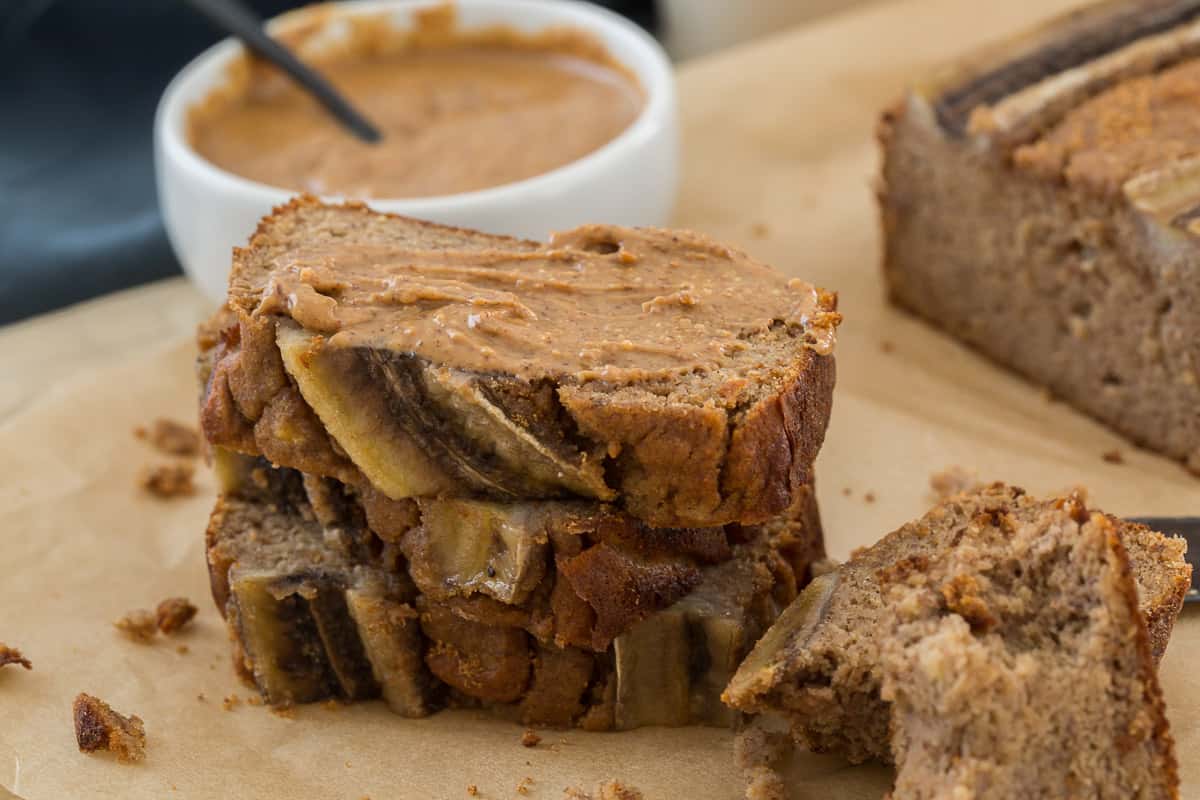 sliced paleo banana bread topped with almond butter