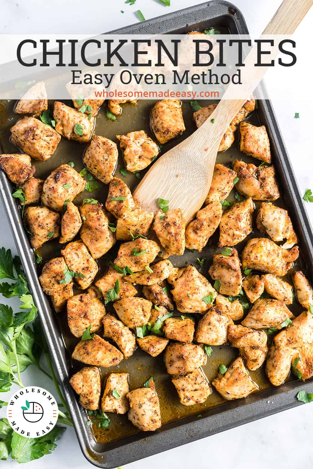 A baking sheet filled with cooked seasoned cubes of chicken with text overlay
