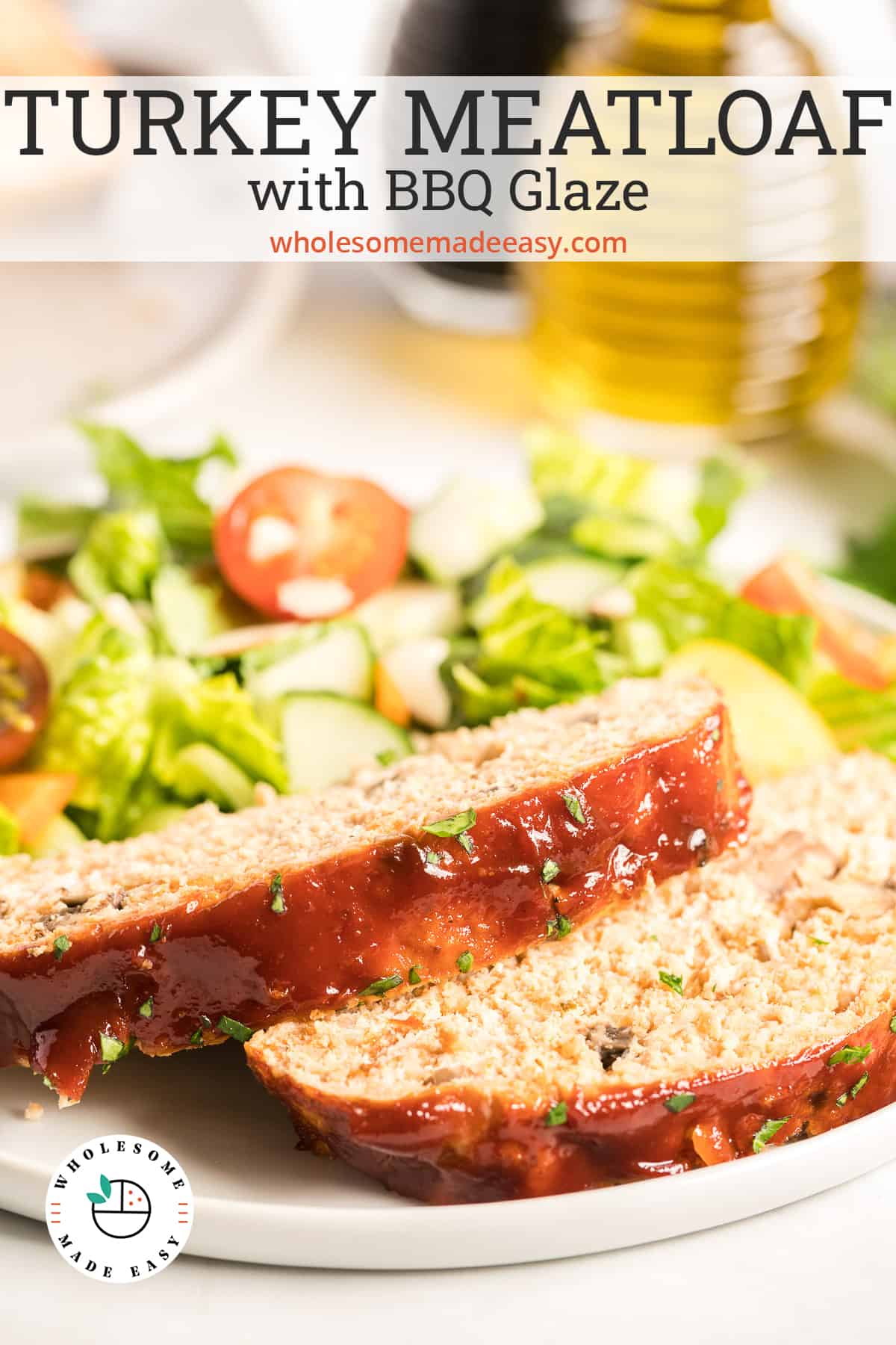 Two slices of turkey meatloaf on a white plate with salad with text overlay.