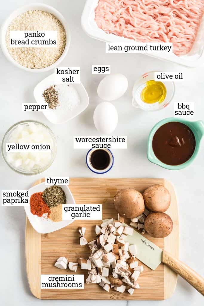 All the ingredients required to make turkey meatloaf on a white surface with text overlay.