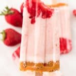strawberry cheesecake popsicle with bite taken out