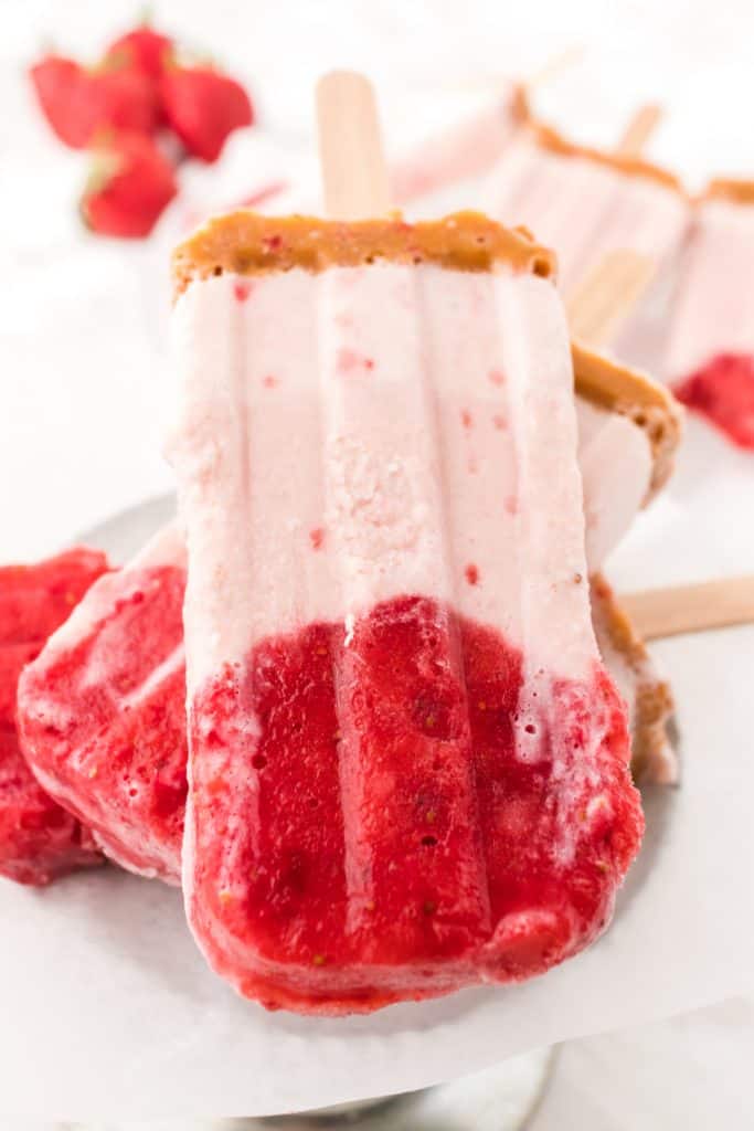 close up of strawberry cheesecake popsicle
