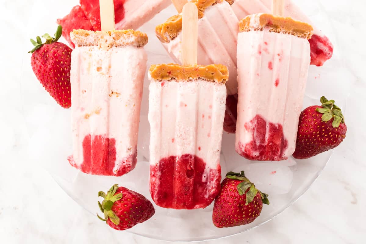 plate of strawberry cheesecake popsicles