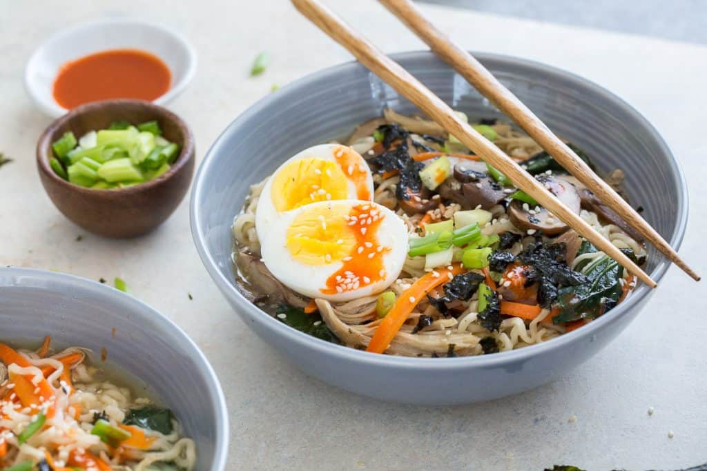 A bowl filled with ramen and a soft boiled egg.