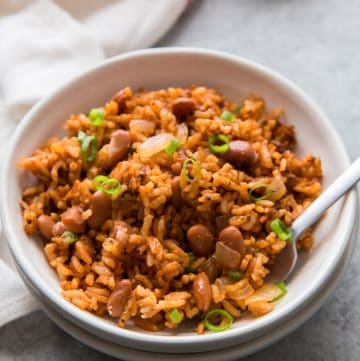low sodium rice and beans in a white bowl with a spoon and napkin