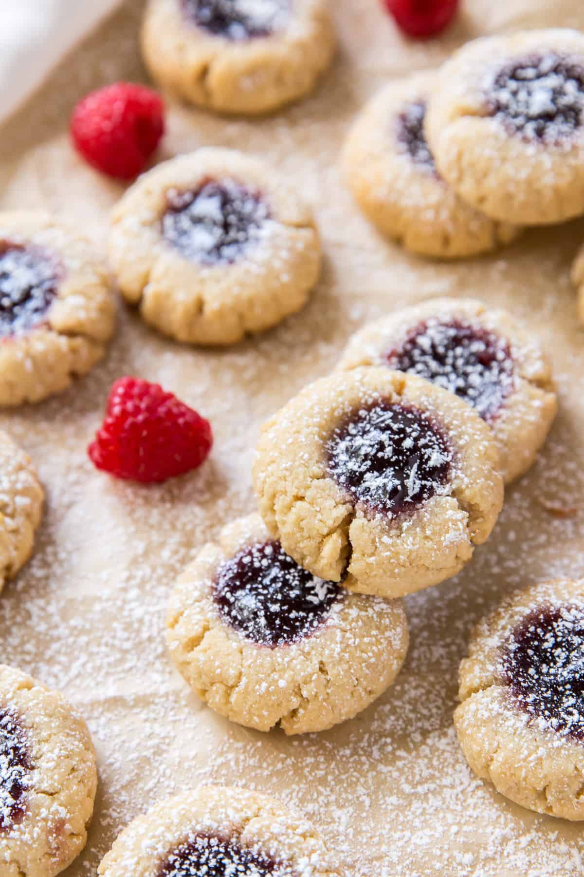 Almond Thumbprints filled with raspberry jam and dusted with powdered sugar.
