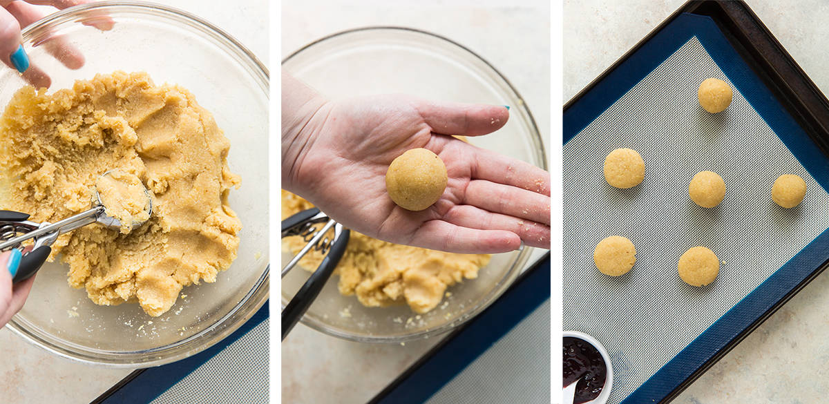 A hand scoops cookie dough with a cookie scoop and forms it into a ball.