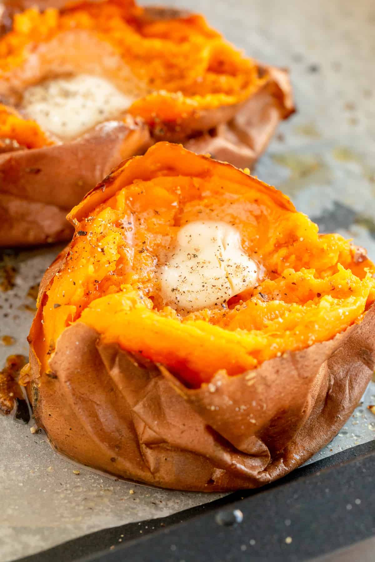 A close up of a sweet potato topped with butter.