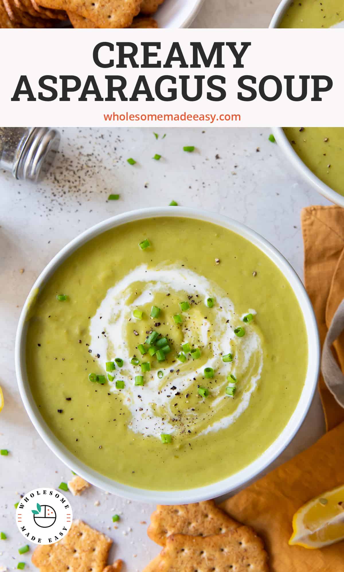Two bowls of Asparagus Soup with crackers around them with text overlay.
