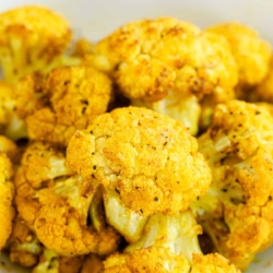 A close up of cauliflower florets with turmeric.