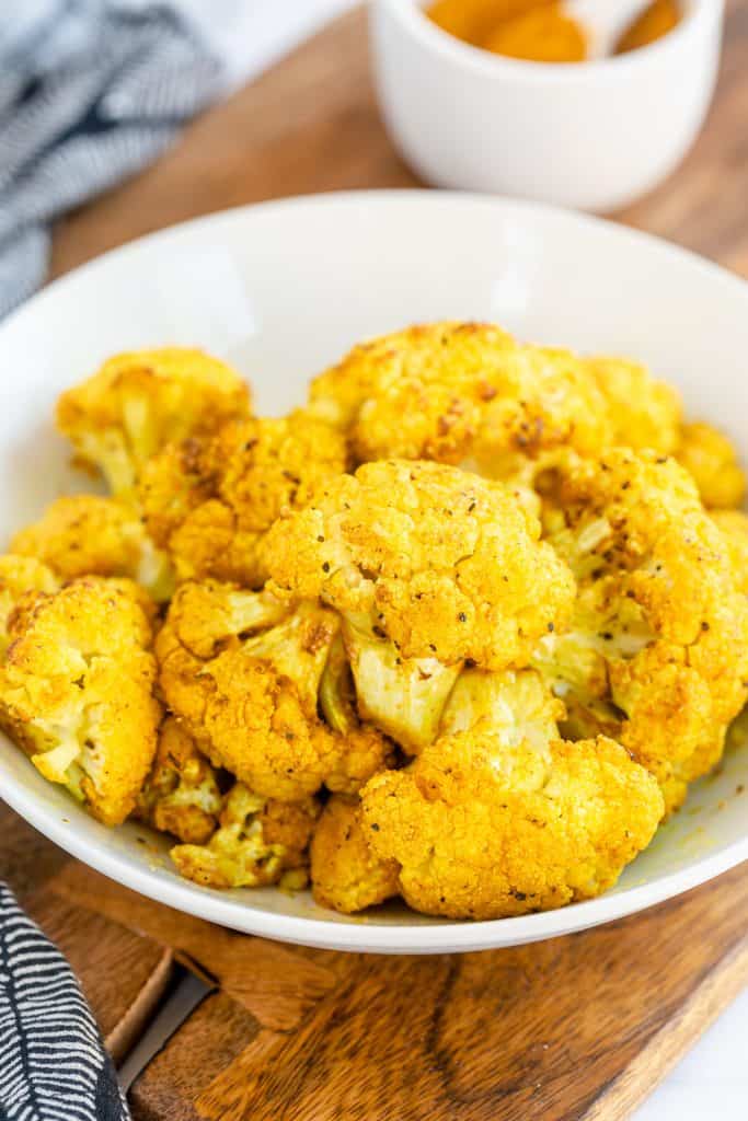 A white bowl filled with Turmeric Roasted Cauliflower.