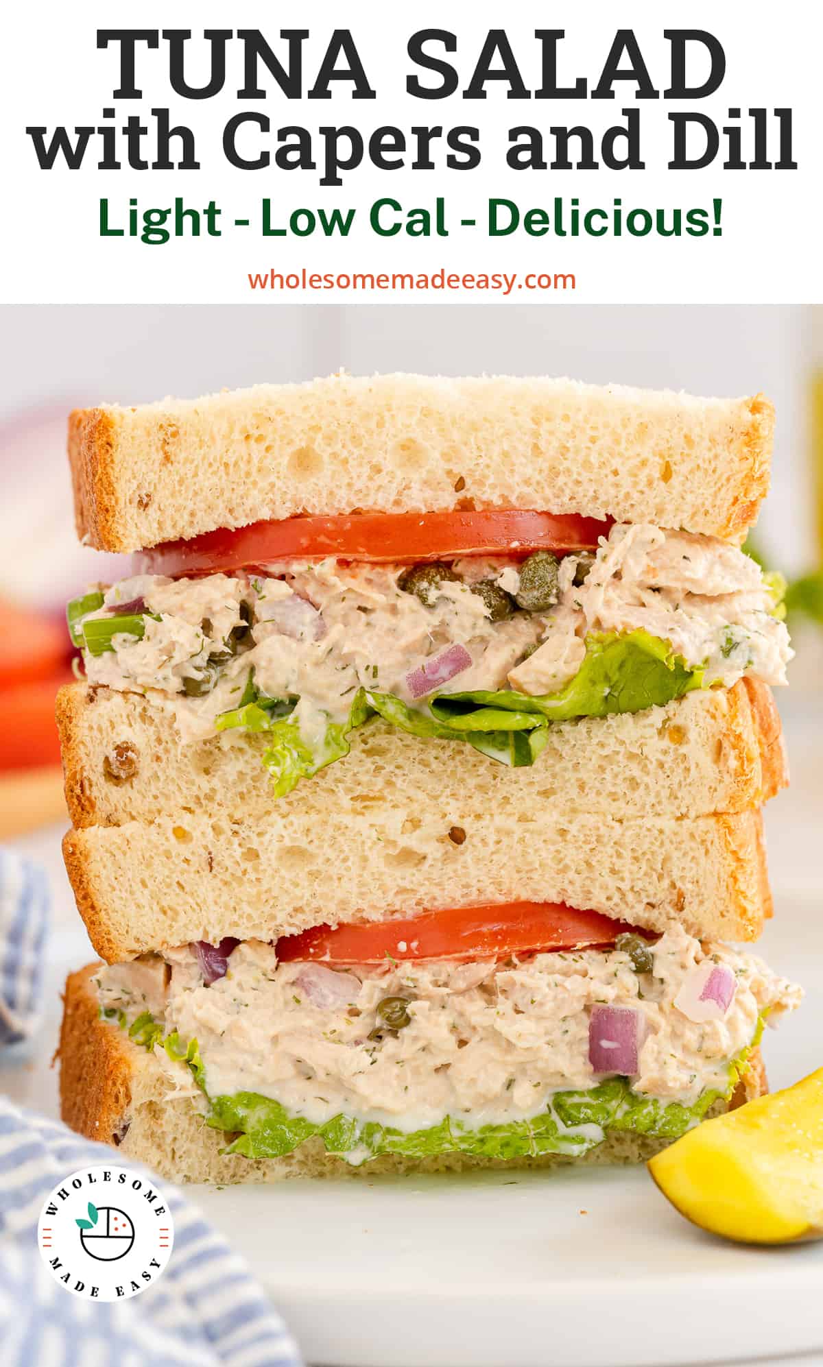 A tuna sandwich cut in half and stacked on a plate with overlay text.