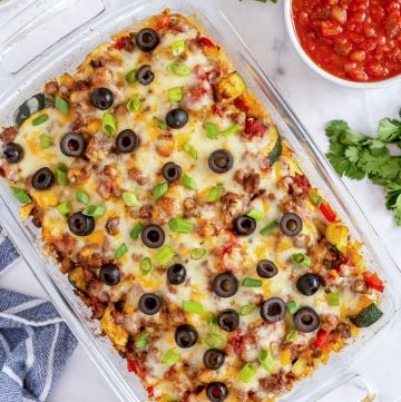 A casserole dish filled with Beef and Veggie Taco Bake shot from over the top.
