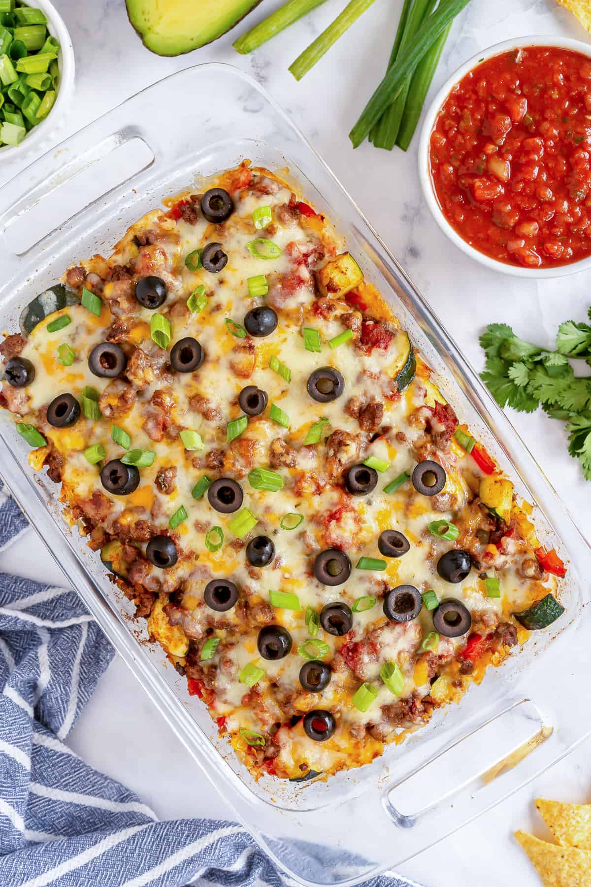 A casserole dish filled with Beef and Veggie Taco Bake shot from over the top.