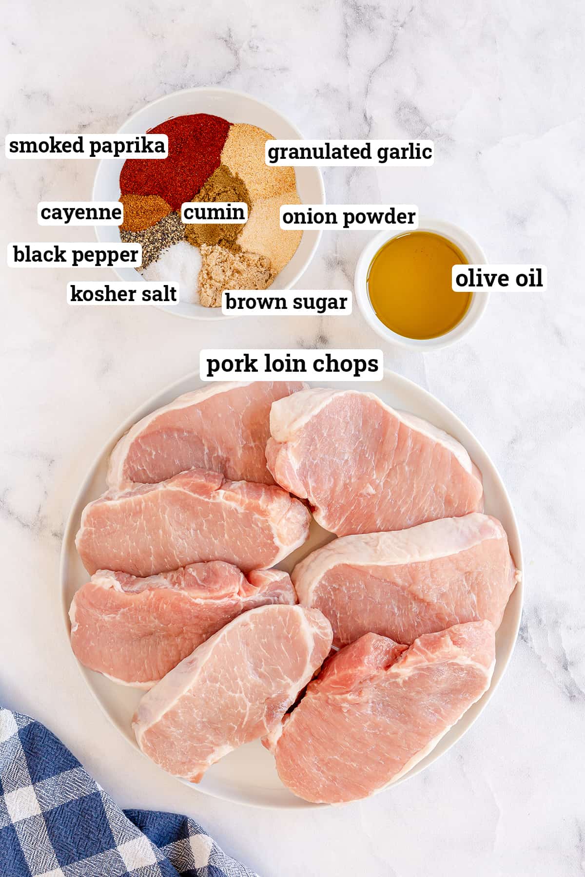 Pork loin chops, dried seasonings, and olive oil with overlay text.
