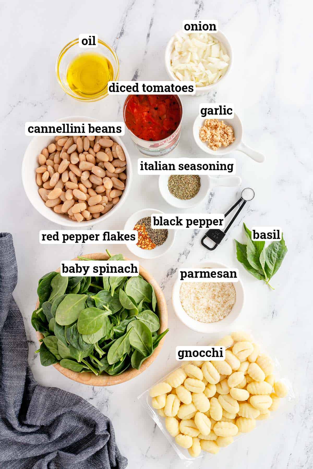 Gnocchi, cannellini beans, spinach and other ingredients with overlay text.