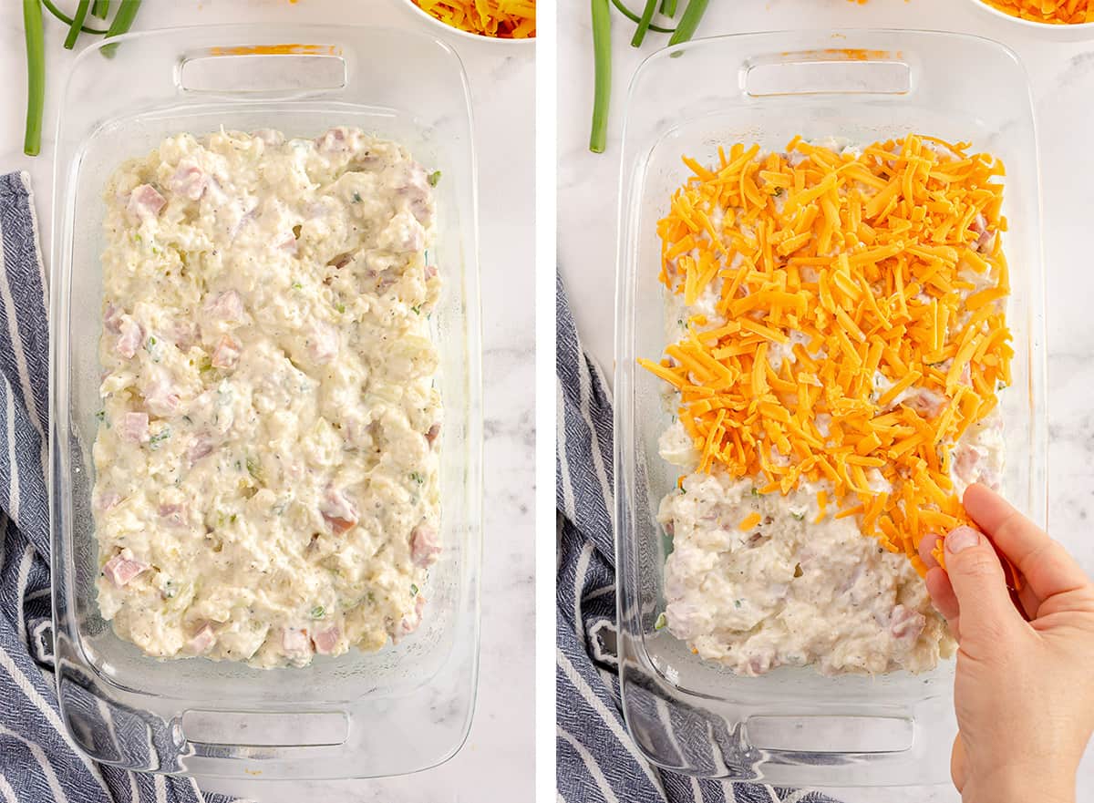 A creamy ham and cauliflower mixture being topped with cheese in a baking dish.