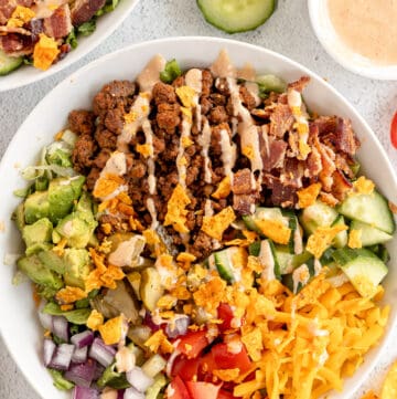 A cheeseburger bowl topped with bbq ranch dressing.