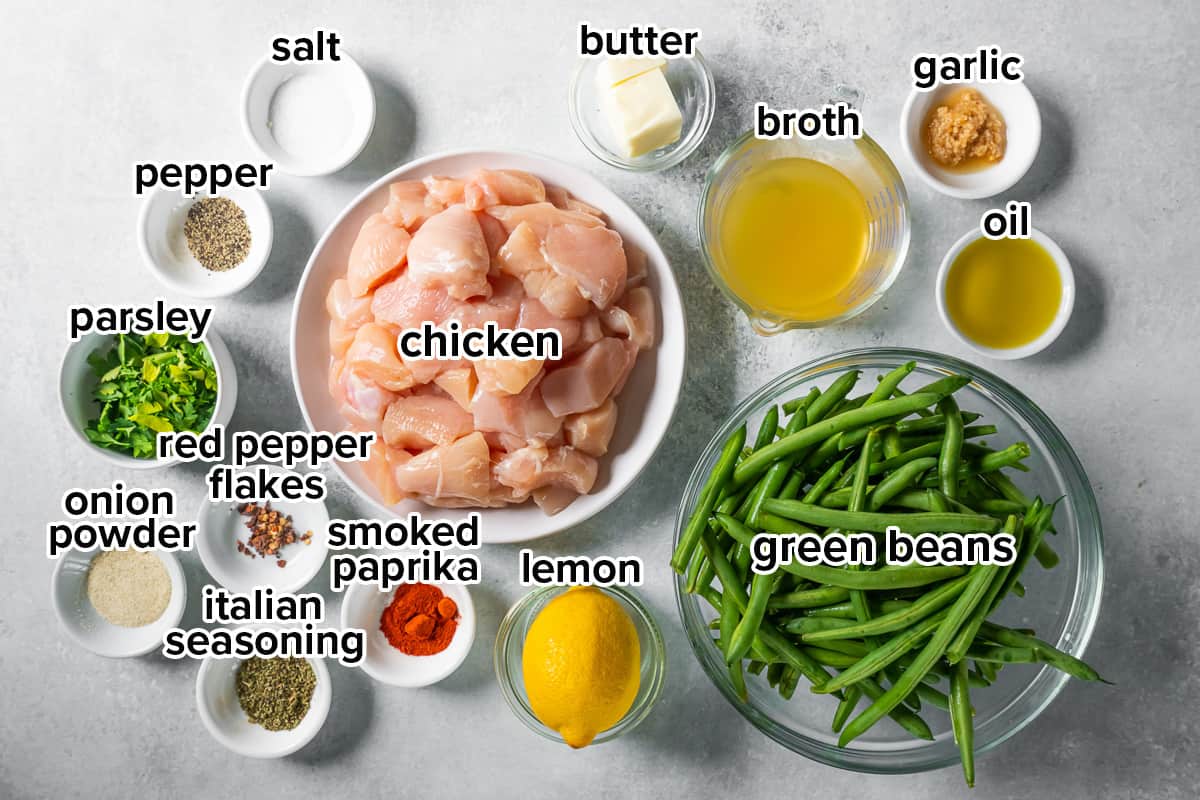Chicken, green beans and other ingredients in bowls on a grey surface with text.
