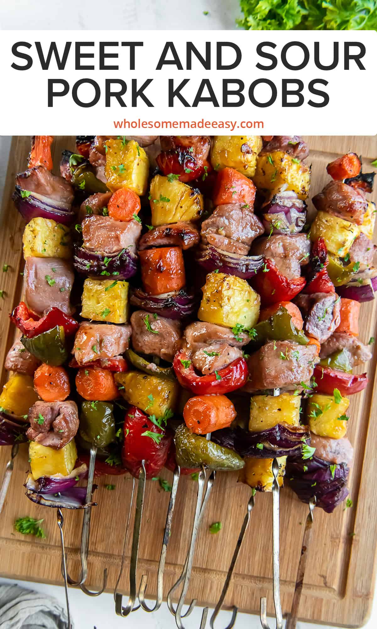 A top down shot of Sweet and Sour Pork Kabobs on a wood cutting board with text.