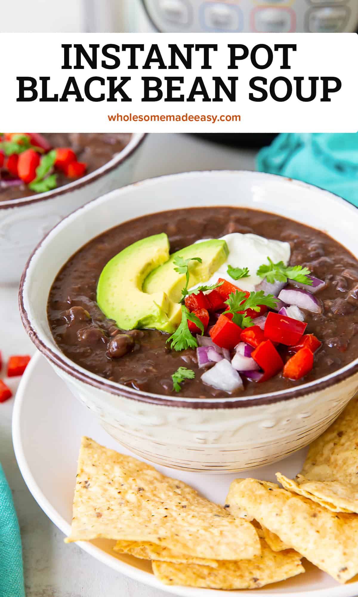Two bowls of black bean soup topped with avocado and sour cream on plates with tortilla chips in front of an Instant Pot with text.