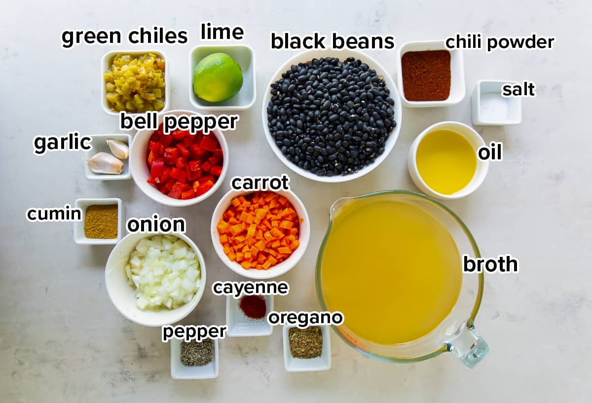 Black beans and other ingredients in bowls on a white surface with text.