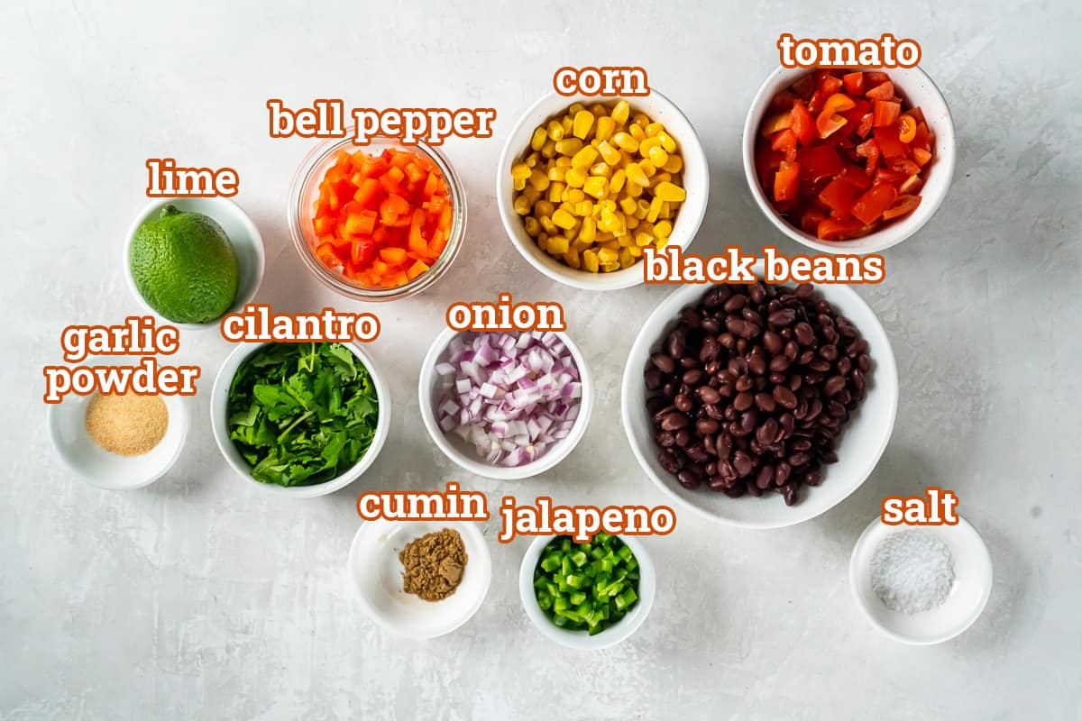 Black beans, corn, tomato, bell pepper and other ingredients in small bowls with text.