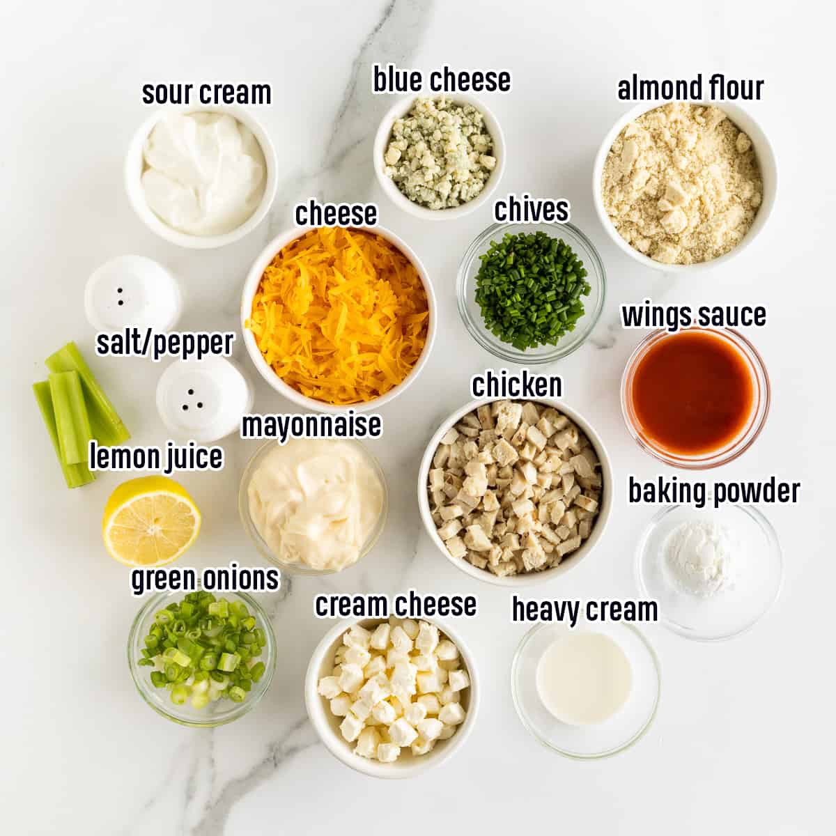 Sour cream, cream cheese, chicken, cheese and other ingredients in bowls with text.
