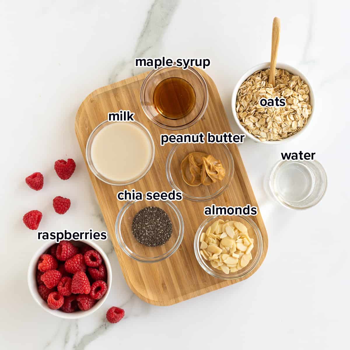 Oats, raspberries, peanut butter and other ingredients in bowls with text.