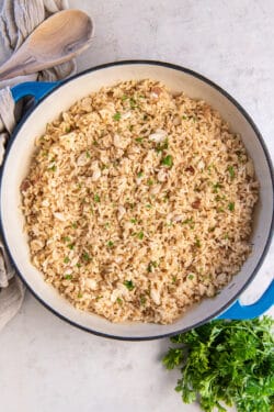 Cooked brown rice with almonds in a skillet.