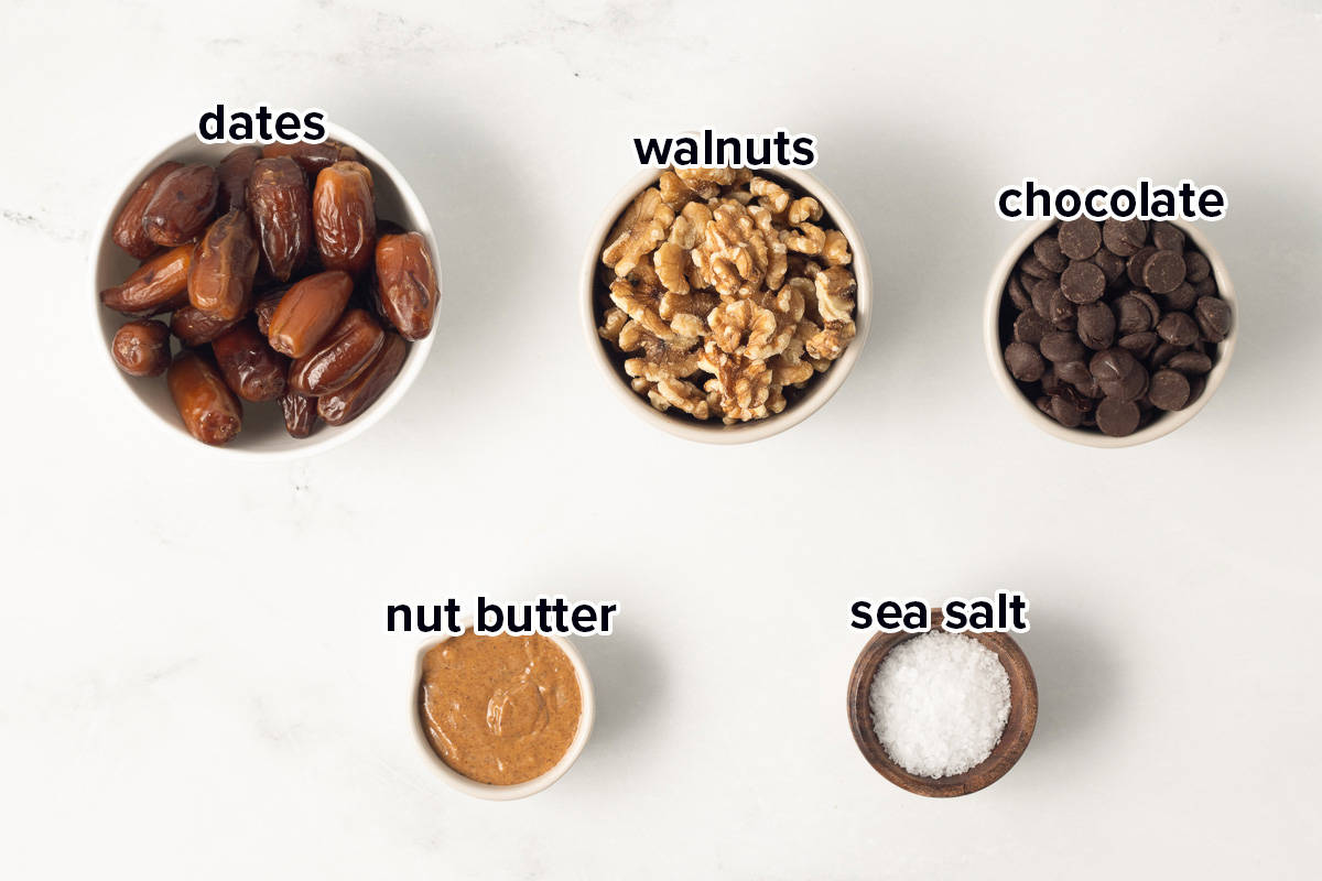 Dates, walnuts, dark chocolate chips, nut butter, and salt in small bowls with text.