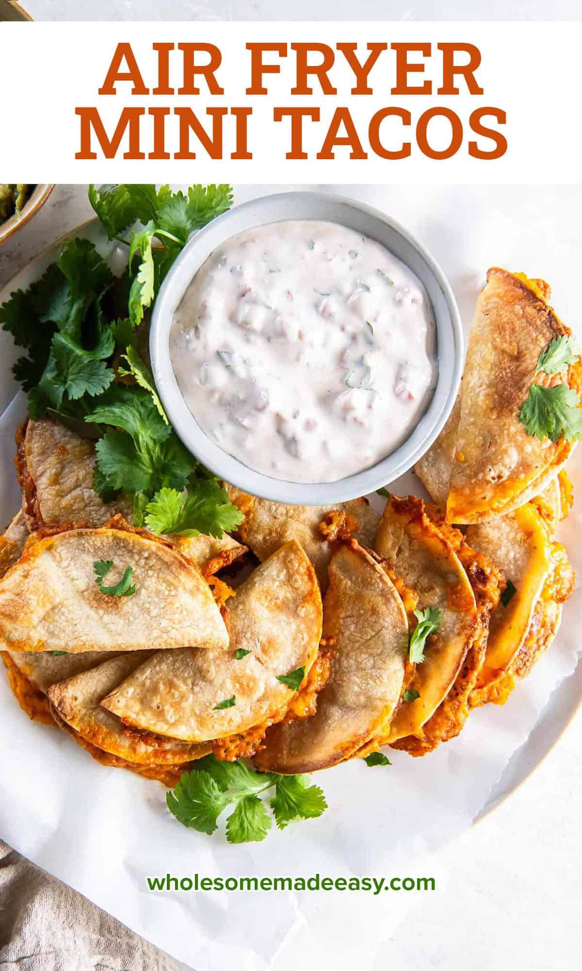 Mini bean and cheese tacos on a white plate with a bowl of creamy salsa dip with text.