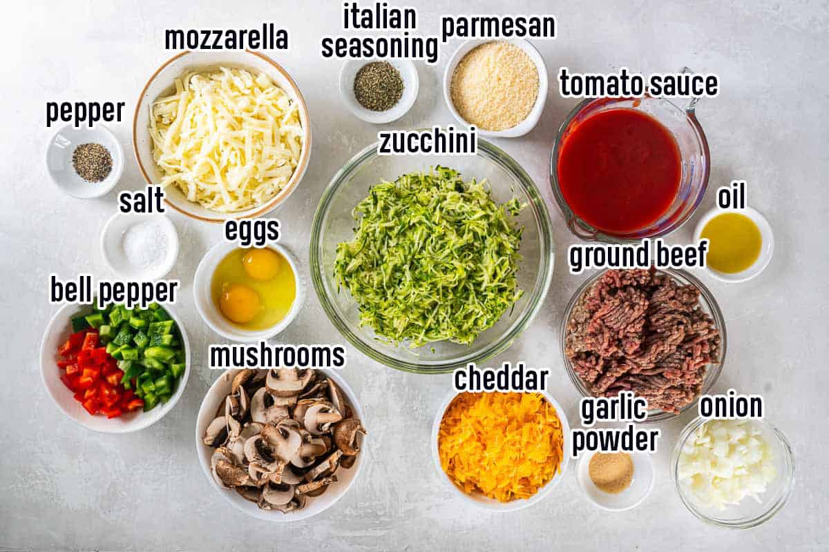 Shredded zucchini, cheese and other ingredients in bowls with text.