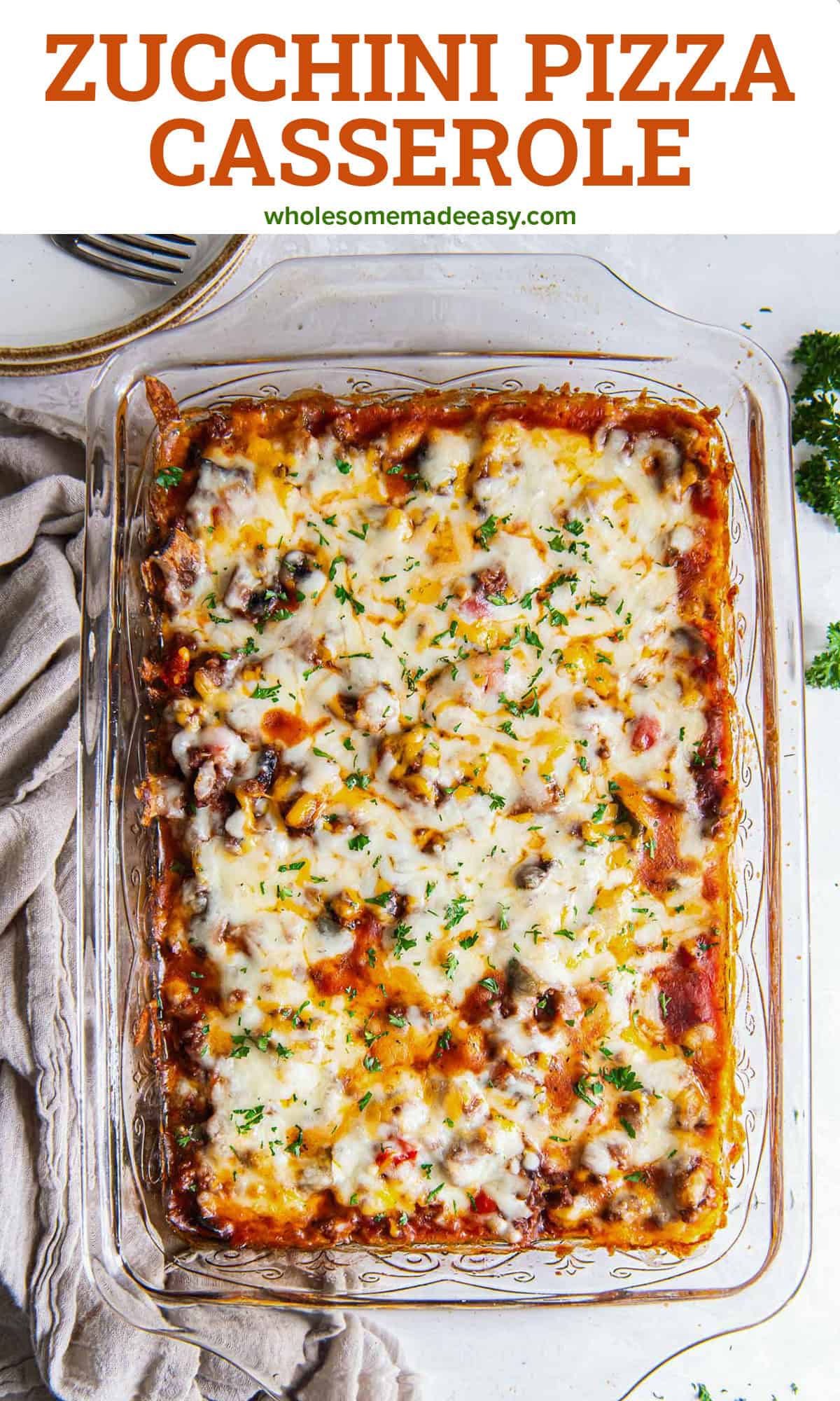 Cheesy zucchini pizza casserole in a baking dish with text.