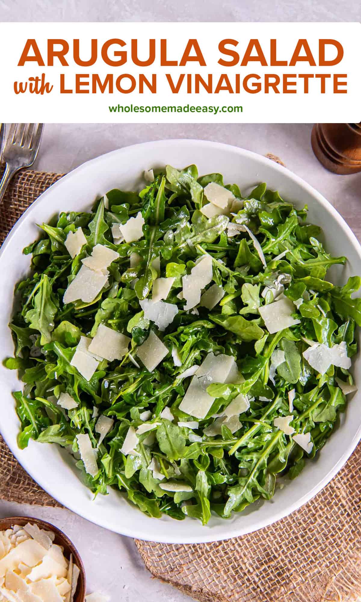Salt and pepper shakers next to arugula salad in a white bowl with text.