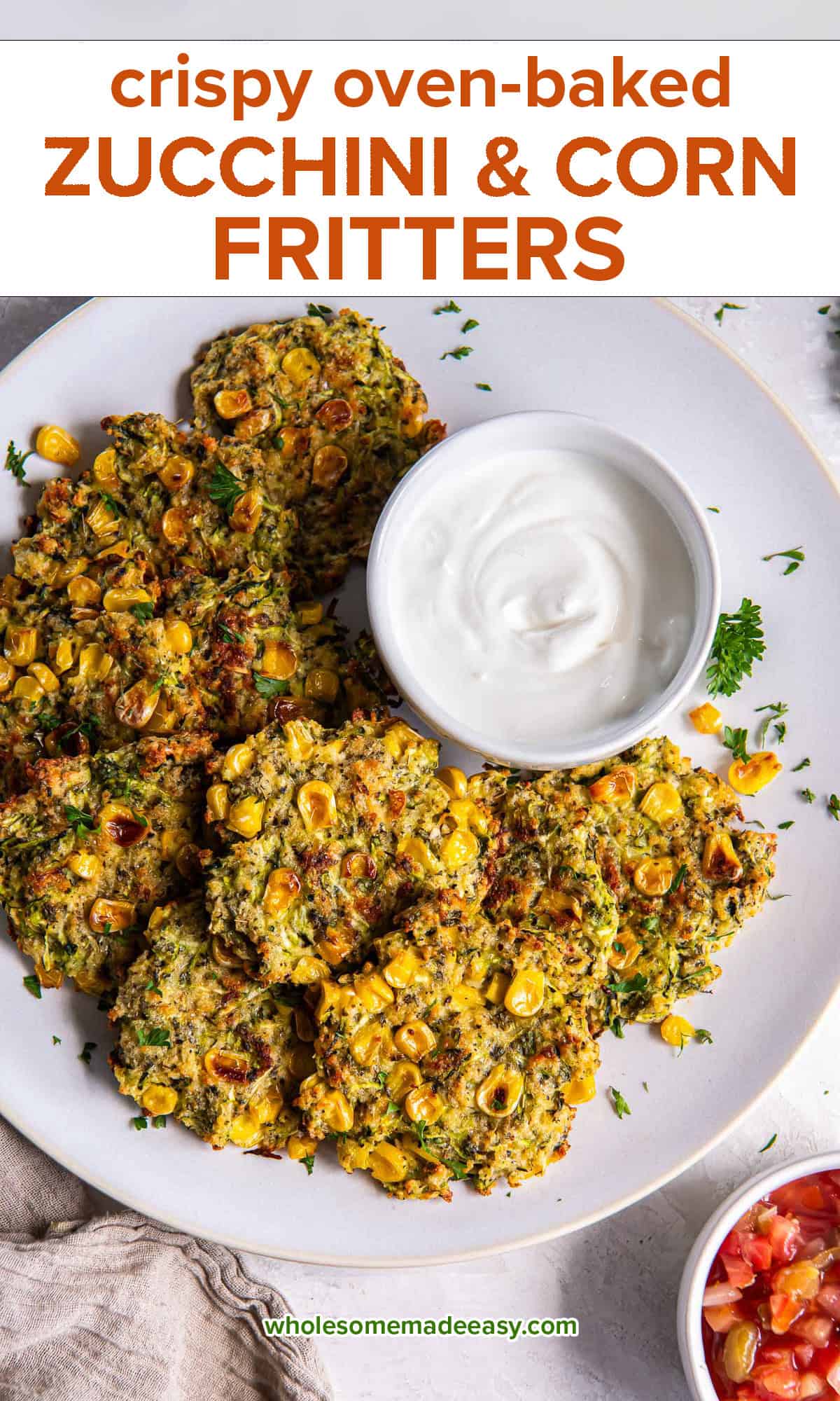 Zucchini and corn fritters on a white plate with a bowl of Greek yogurt and a bowl of salsa nearby with text.