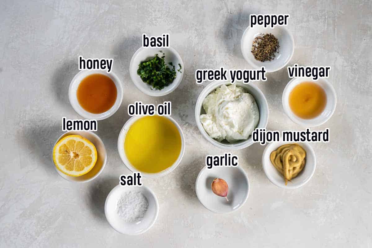 Greek yogurt, honey, oil and other ingredients in bowls with text overlay.