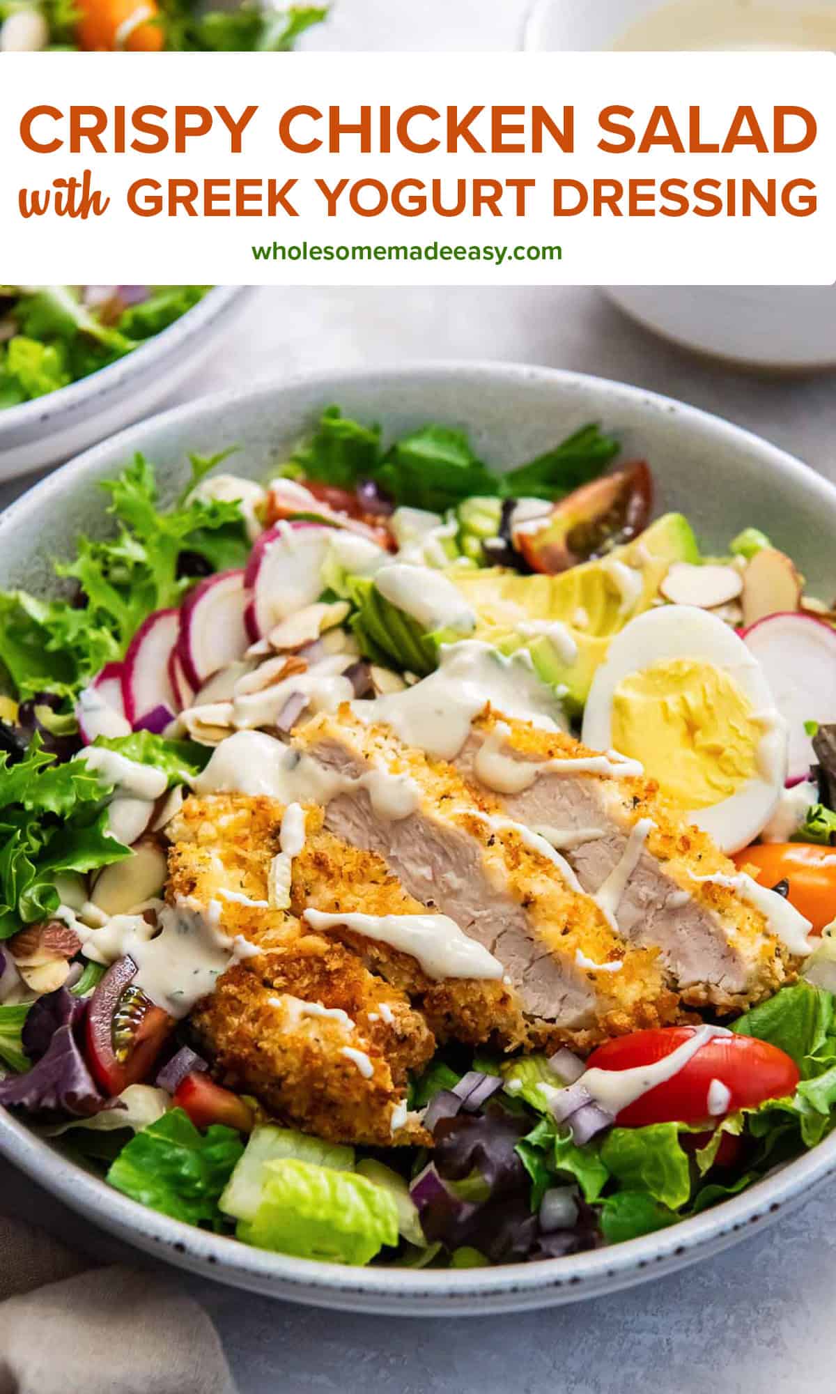 A salad with crispy breaded chicken, avocado, radish, and greek yogurt dressing with text overlay.