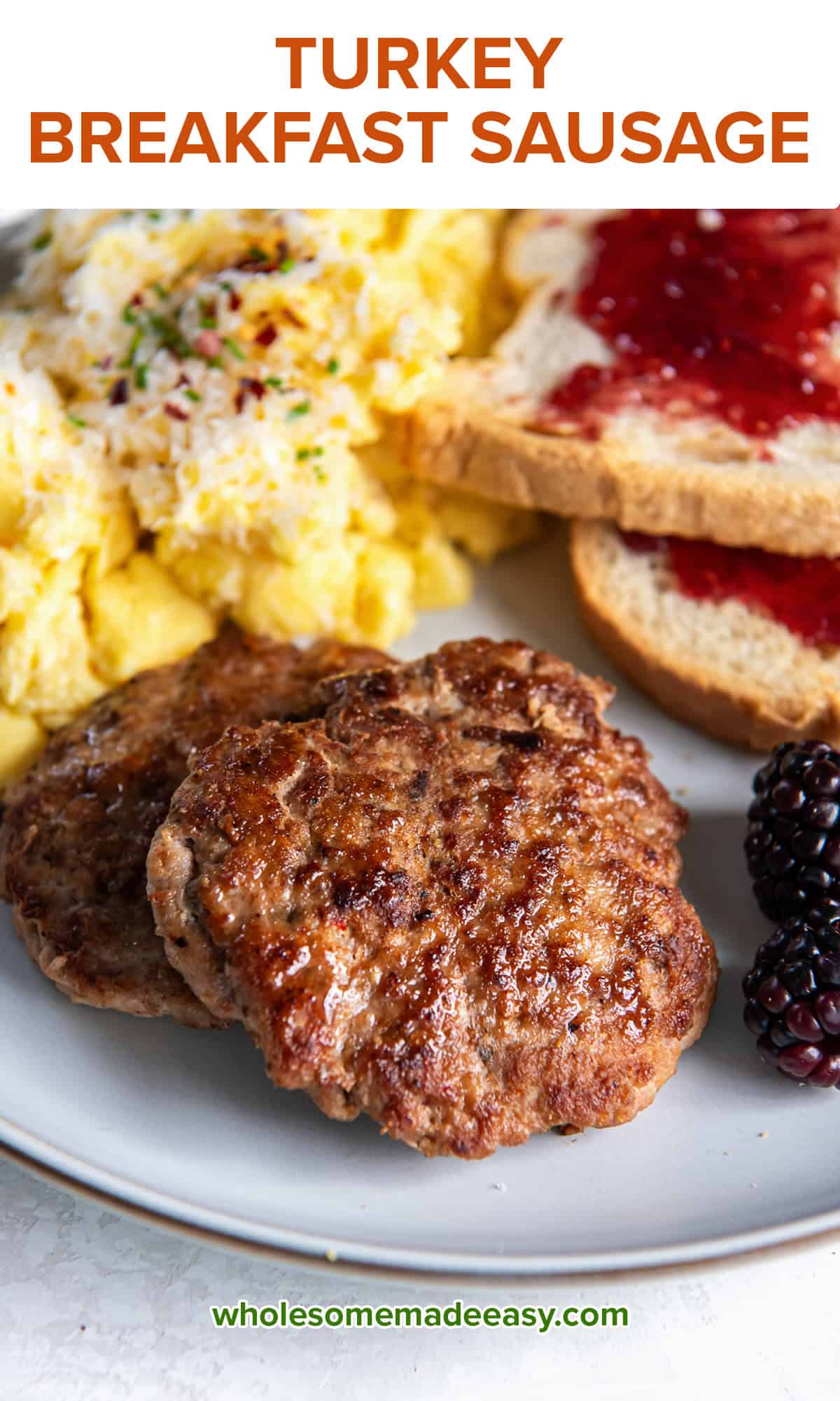 Two turkey breakfast sausage patties on a plate with scrambled eggs and toast with jelly.