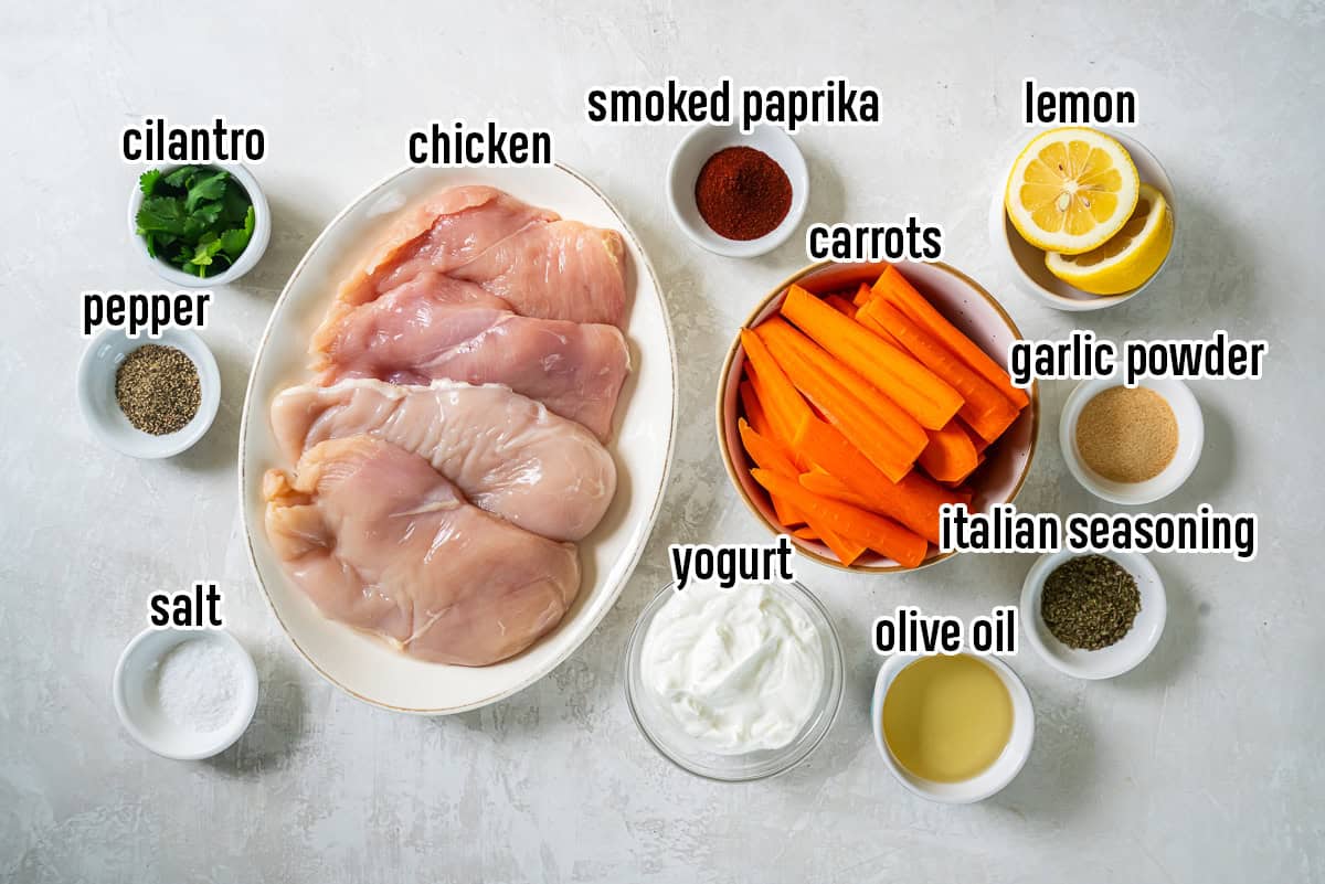 Boneless chicken breasts, carrots, spices, lemon and other ingredients in bowls with text overlay.