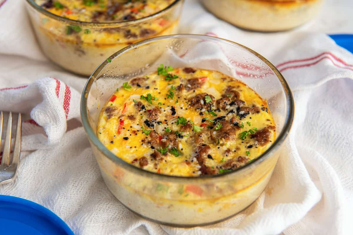 A high protein egg bake with cheese and sausage in a small glass container.