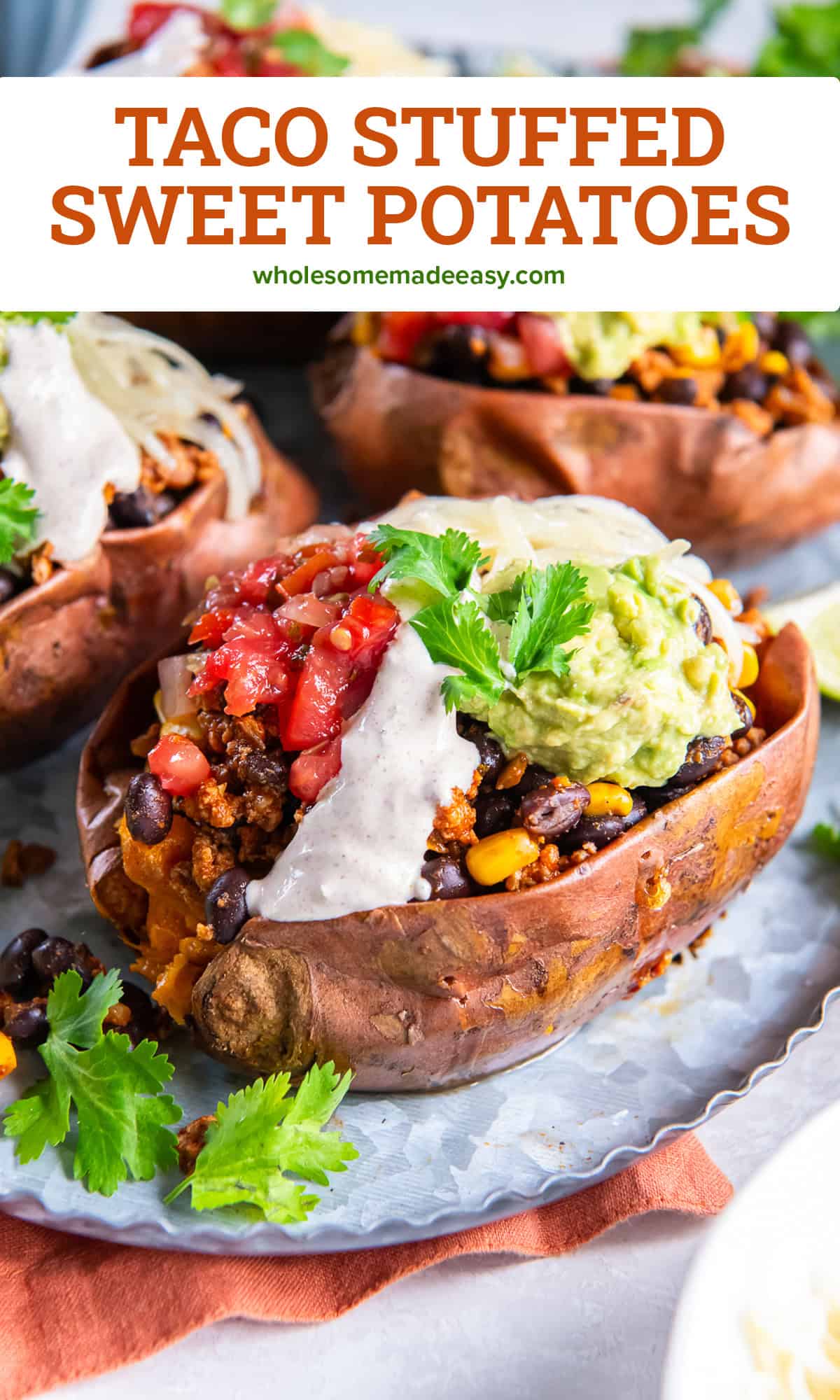 A taco stuffed sweet potato on a metal platter topped with greek yogurt sauce, salsa, and guacamole with text overlay.