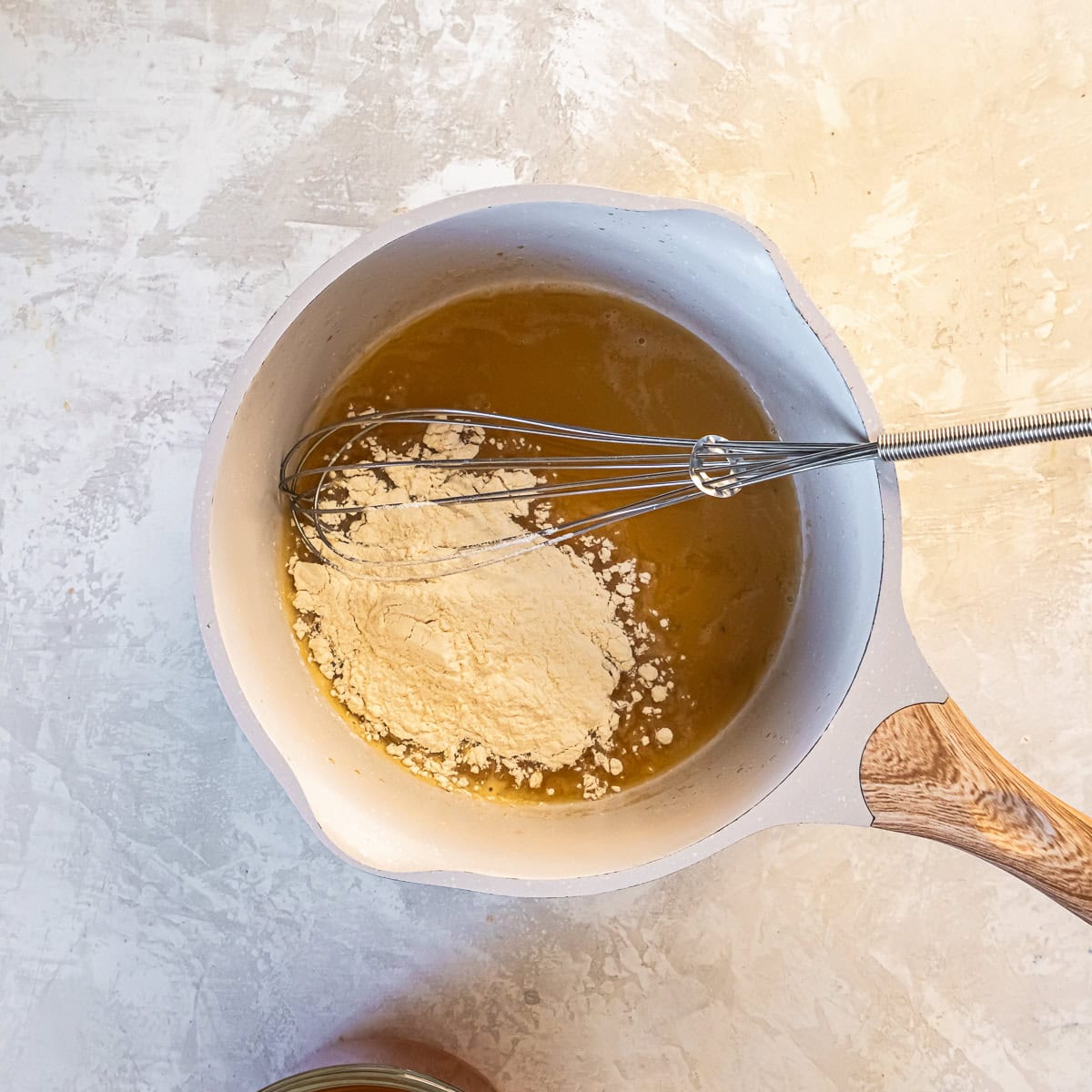 Flour added to turkey drippings in a saucepan to form a roux for gravy.