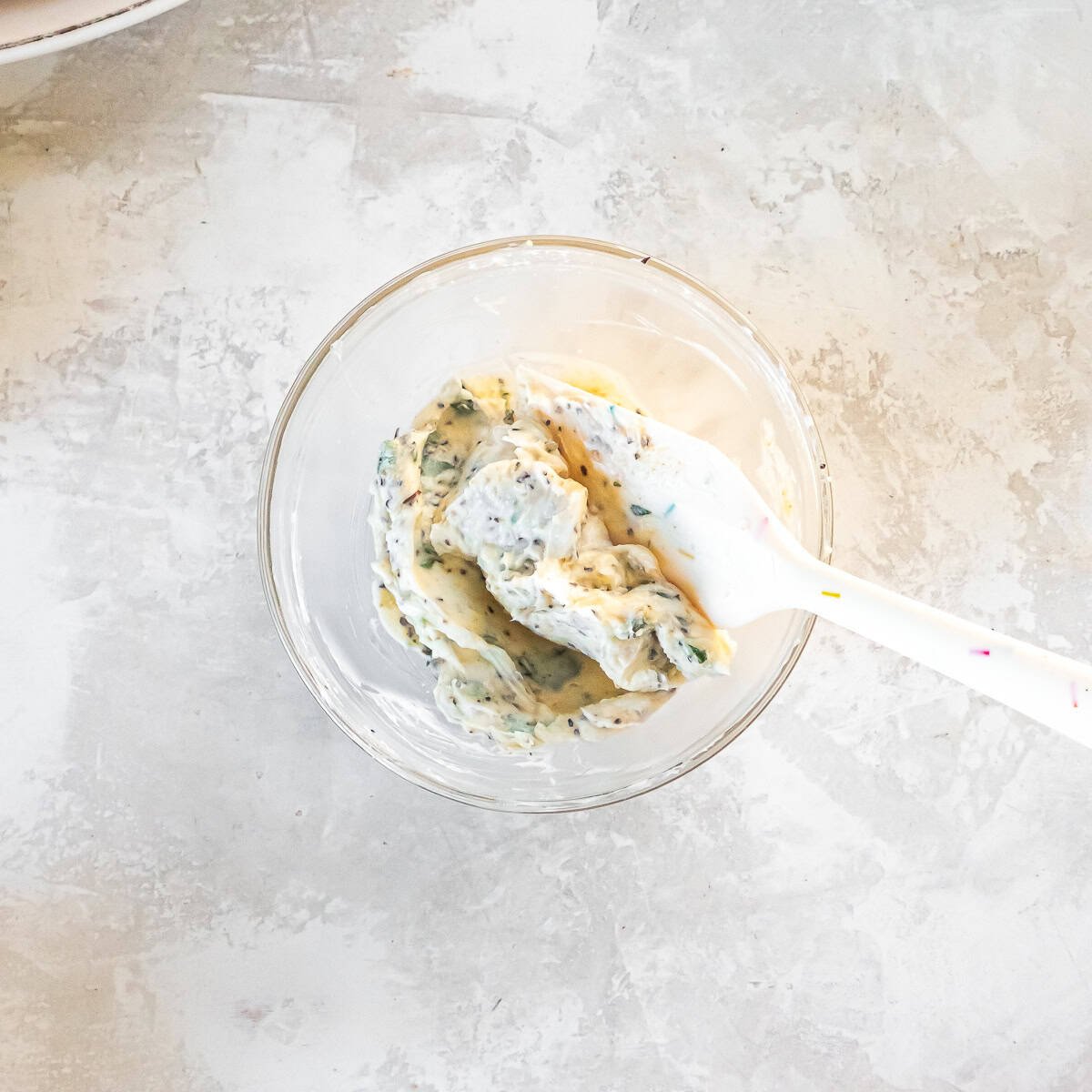 Herb butter mixture combined in a small bowl for seasoning the turkey breast.