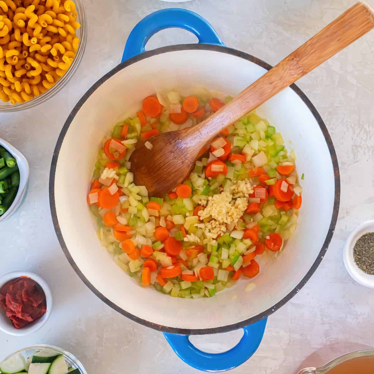 Sautéed onion, carrot, and celery mixture in a Dutch oven.